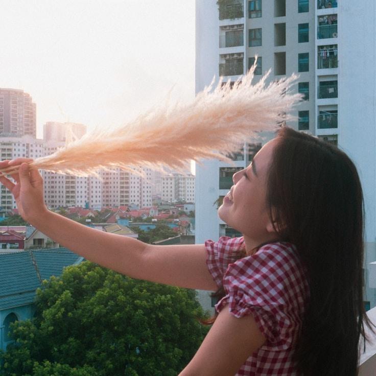 Kaveri Mehta, Lead Design Curator at Breeze Field Lab, reviewing corporate floral arrangements